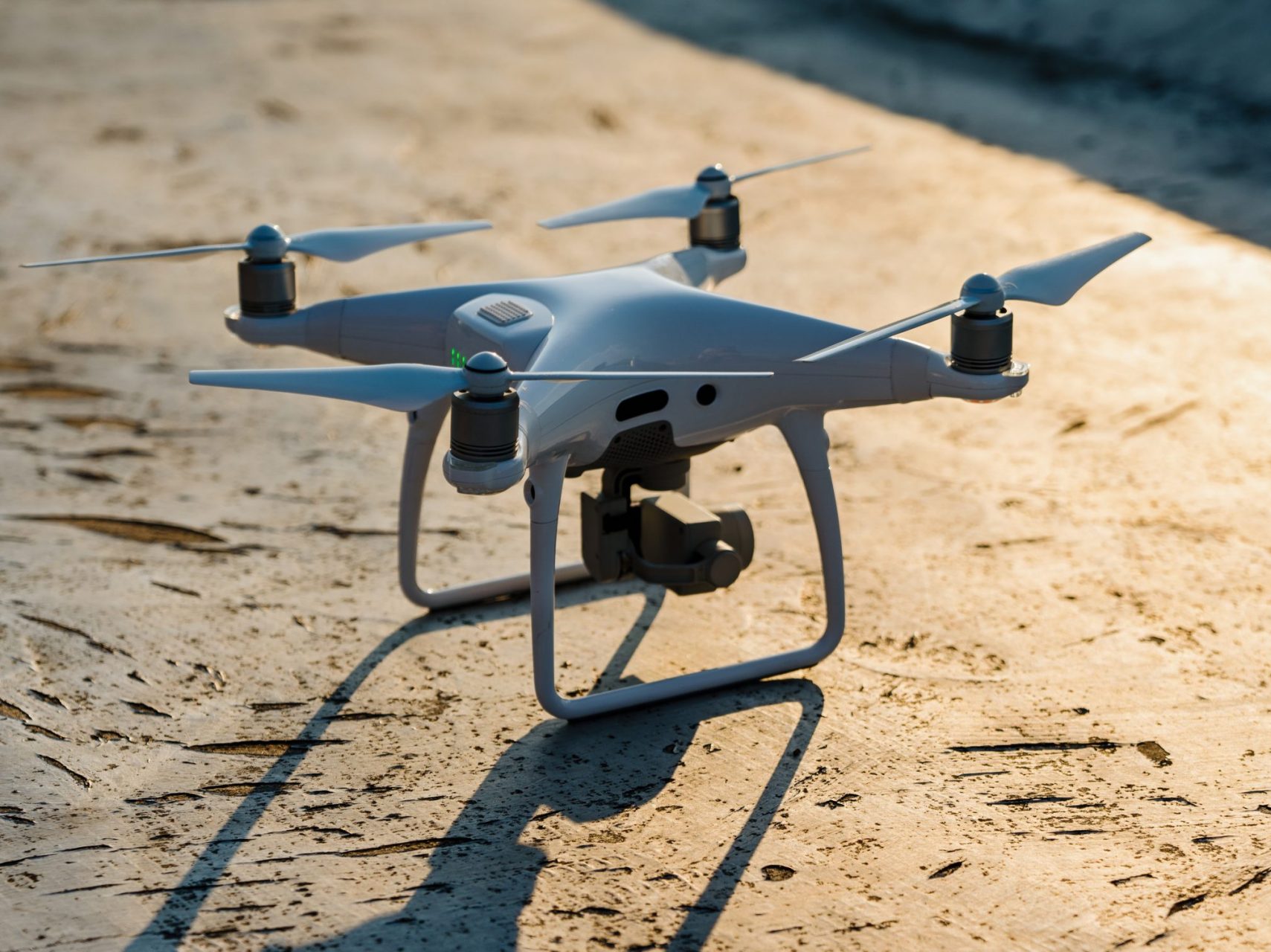 Close up white drone quadcopter with digital camera outdoors